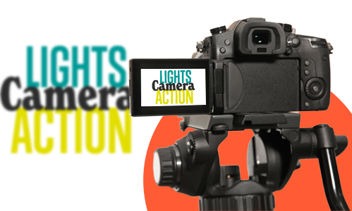 Image of a video camera with the words 'lights, camera, action' on the camera screen